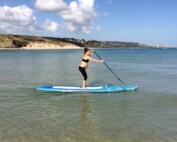 Pregnant woman paddleboarding standing
